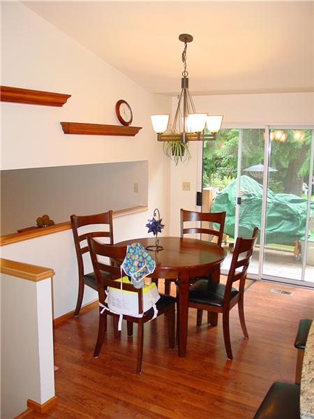 Dining area opens up to deck outside, and features view down to lower level of home.
