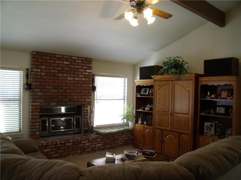 Family room features brick fireplace w/insert