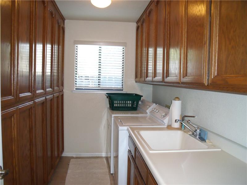 Huge laundry room with cabinets & sink