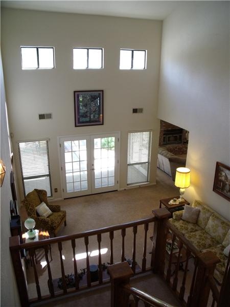 Spectacular living room with 24' ceilings, flooded w/natural light