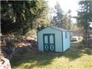 storage shed in corner of back yard