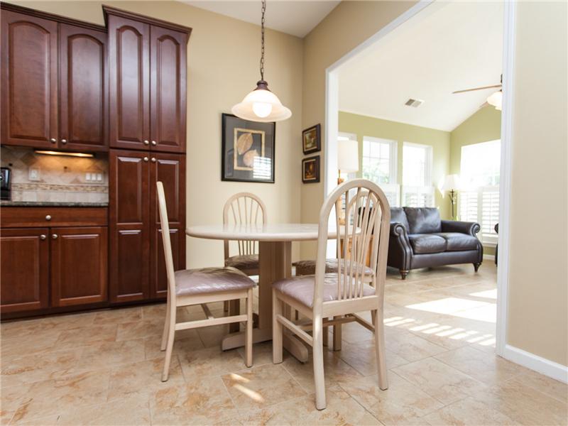 Tile flooring extends from kitchen into sunroom