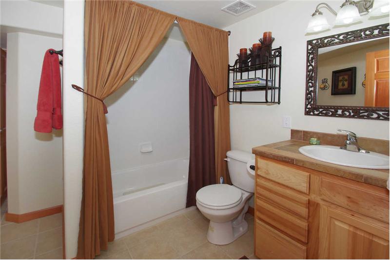 Full basement bath with linen closet and kitchen height vanity. 