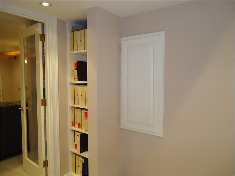 Twin built in book shelves at entrance to theater room