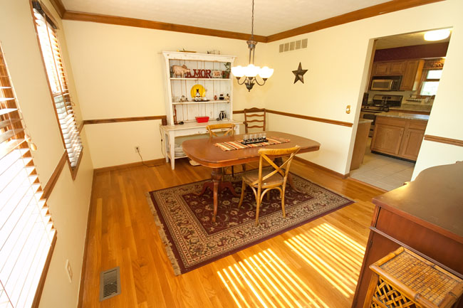 Dining room, wood floors, chandelier and chair rail