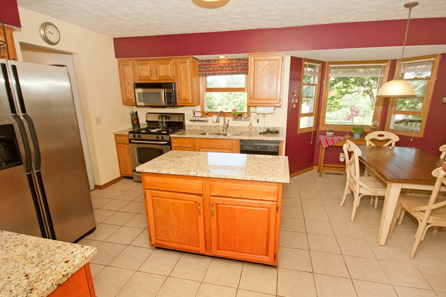 Bay windows, island, wood cabinets and pantry