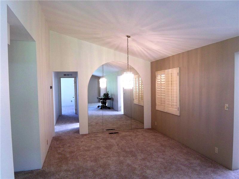 Spacious dining room with views of side yard and pation
