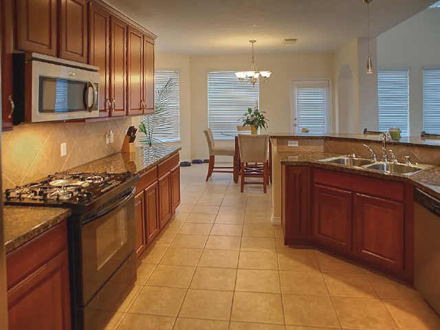 The rich-looking cabinets are set off by the granite counters.