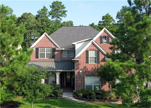 Beautifully treed front yard compliments the home.