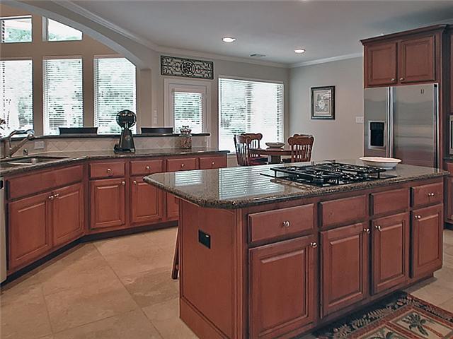 Island kitchen, granite counters & exquisite cabinetry.