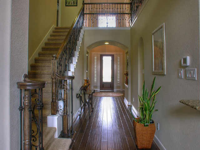 The entry with wood floors & leaded glass front door.