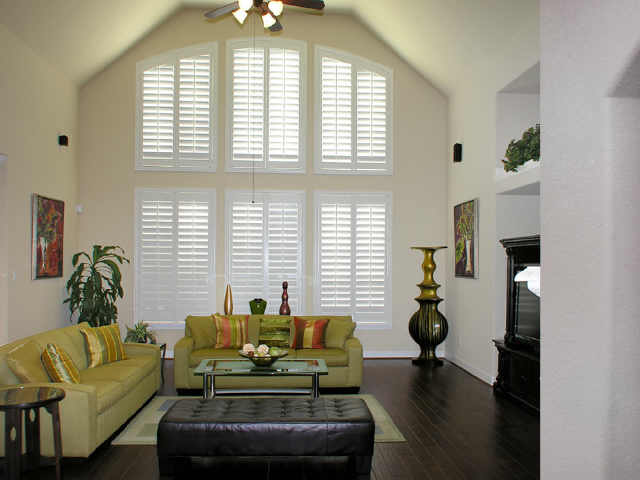 The wall of Plantation shutters in the den.