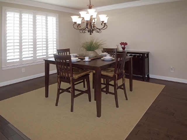 The dining room with crown molding and Plantation shutters.