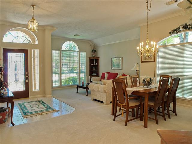 The leaded glass front door opens to the tiled entry.