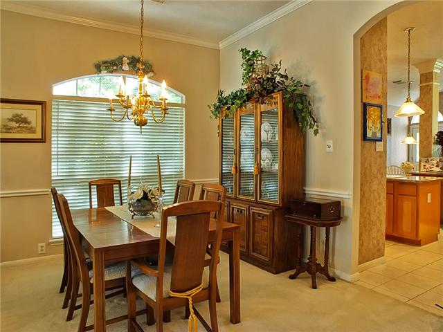 The formal dining room with crown molding & chair rail.