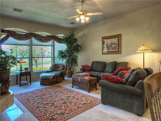 The den offers a wall of windows with a view of the second fairway.