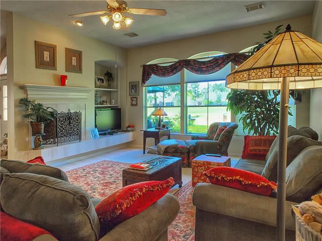 The spacious den has a built-in for media plus a fireplace.