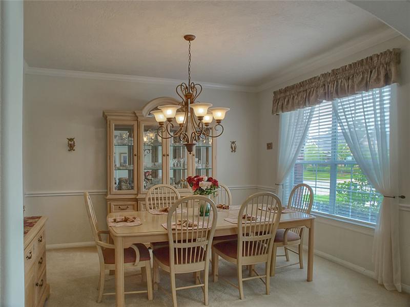 Formal Dining features a chair rail, crown molding & a serene setting.