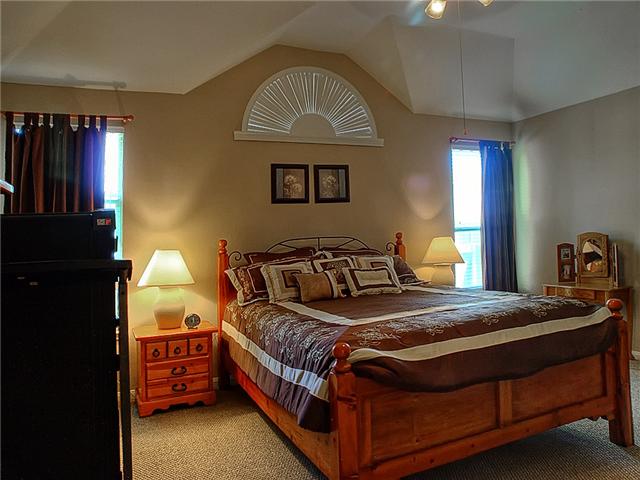 The master bedroom is spacious & serene.