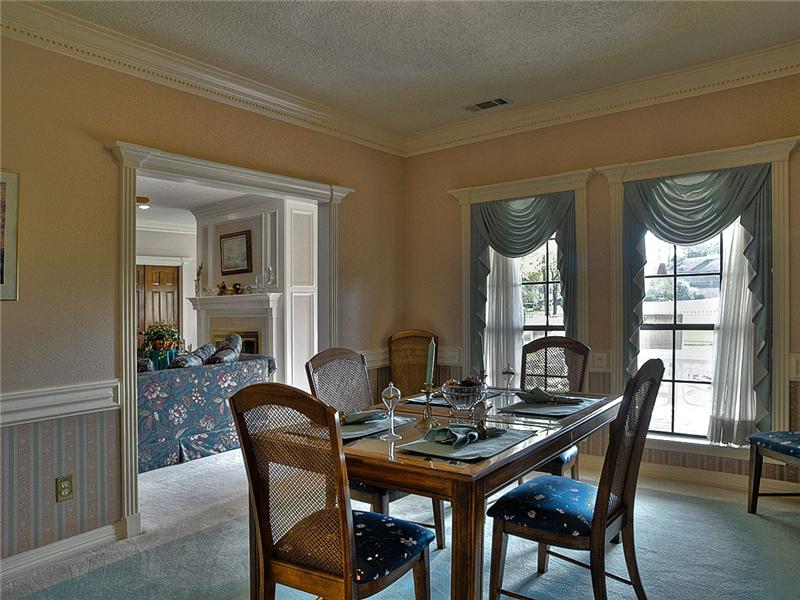 Formal dining room with crown molding & chair rail.