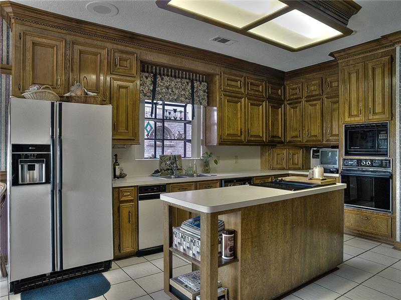The island kitchen has plenty of counter & cabinet space.
