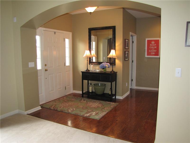 Entry Foyer with arched opening, wood floors