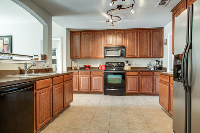 Enjoy cooking in your spacious kitchen with decorative lighting.