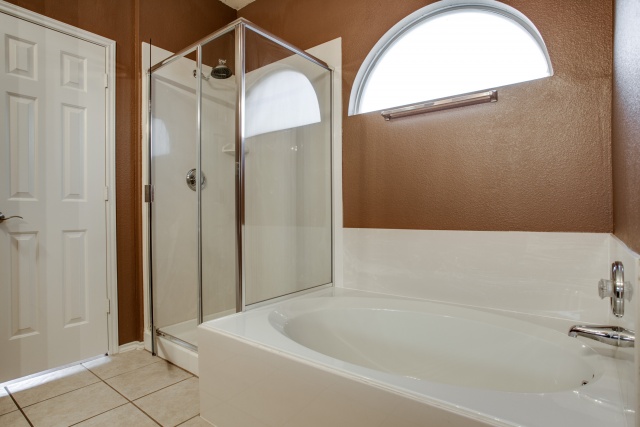 The master bath features a garden tub and separate shower.