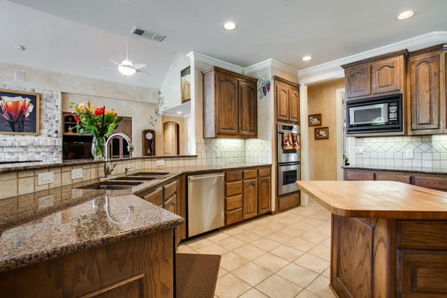 The upgraded kitchen includes a double oven and stainless steel appliances.