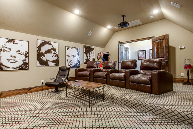 The large media room features custom built-ins. You will feel like you are at the theater!