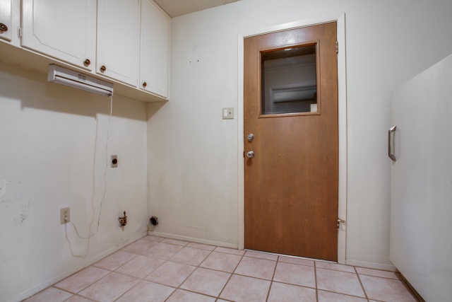 Full size utility room with built-in cabinets!