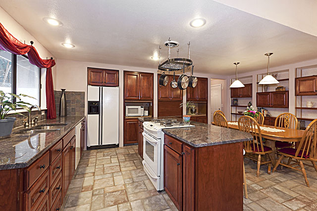 New granite countertops, pot rack, and large walk in pantry