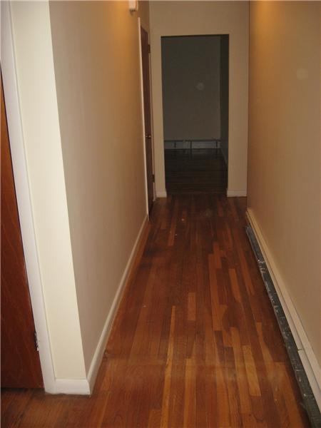 Hallway with hardwood floors.