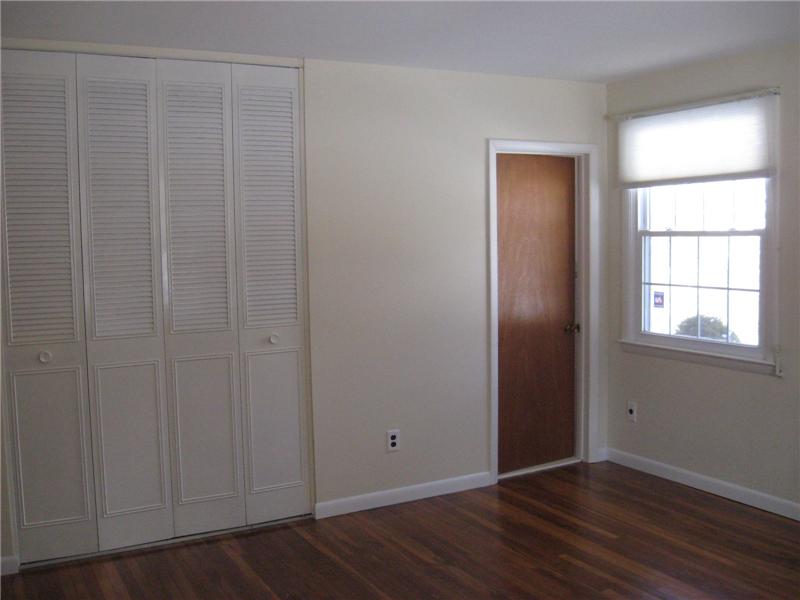 Master bedroom with beautiful hardwood floors, lots of natural sunlight and master bath.