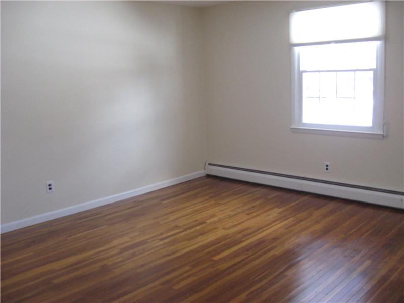 Bedroom with hardwood floors.