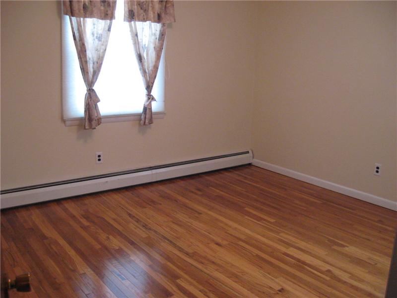 Bedroom with hardwood floors.