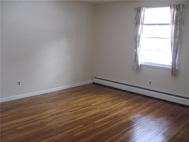 Bedroom with hardwood floors.