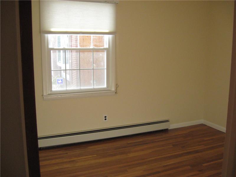 Bedroom with hardwood floors.