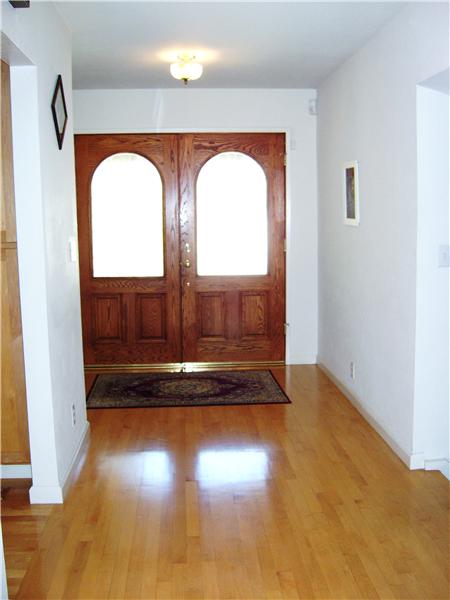 Gleaming Maple Flooring & Impressive Custom Double-Door Entry!