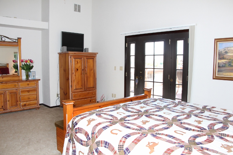 Master suite has walk in closet, jetted tub, glass block shower, and patio access