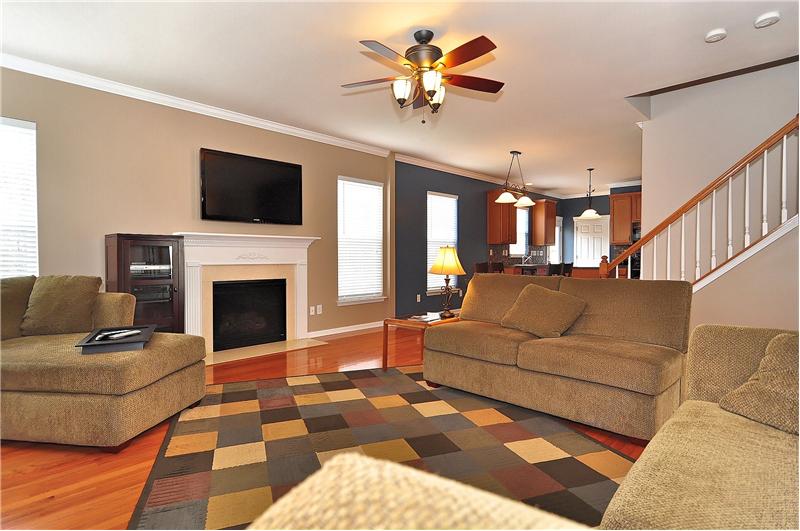 Beautful greatroom features those gleaming wood floors, included flat-screen TV & a gaslog fireplace