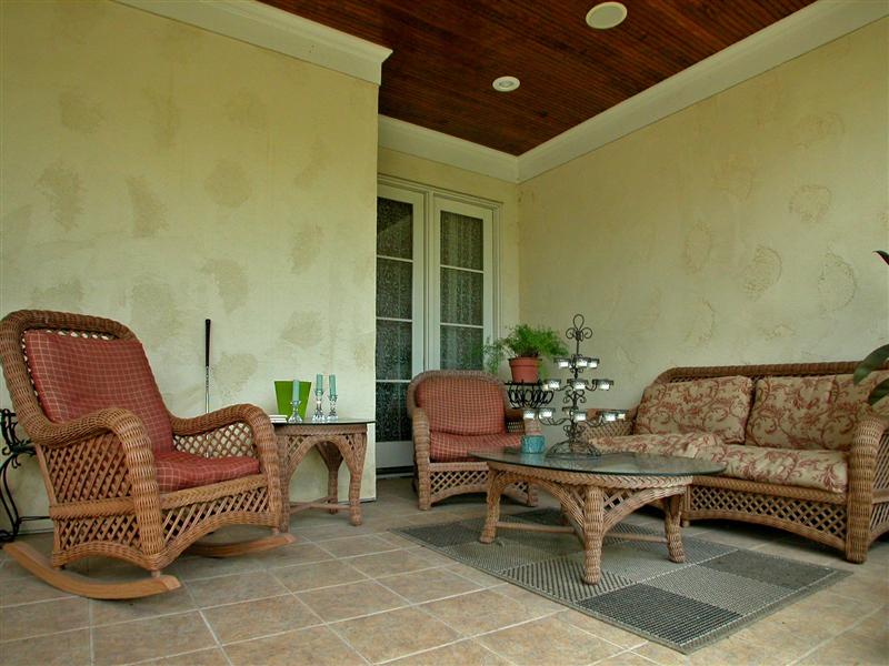 Covered porch features tile flooring & fan
