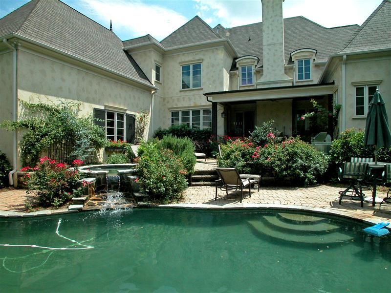 Two-tier stone patio surround pool & spa