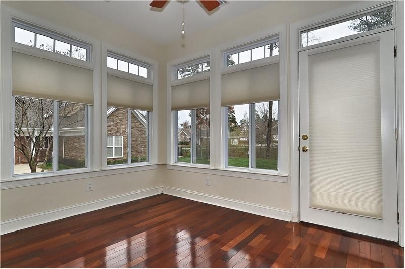 Sunroom has 'walls of windows', teak hardwoods & backyard access
