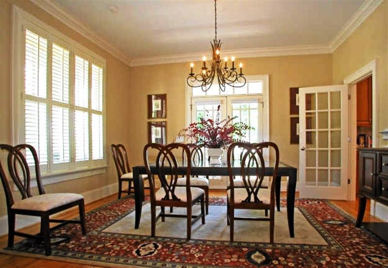 The dining room also has hardwoods, custom moldings and french doors to outside