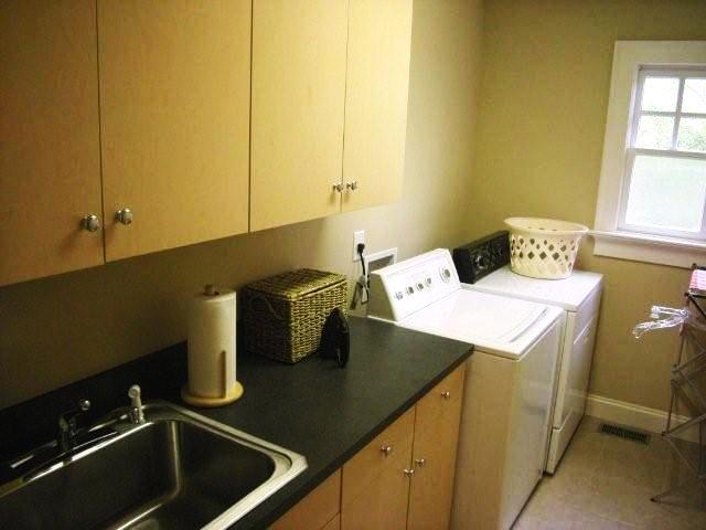 The laundry room on the main level has cabinets, counter space and a sink