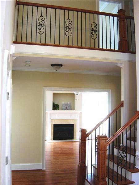 Upon entry into the two-story foyer you are greeted by a wrought iron stair case and beautiful hardwood floors