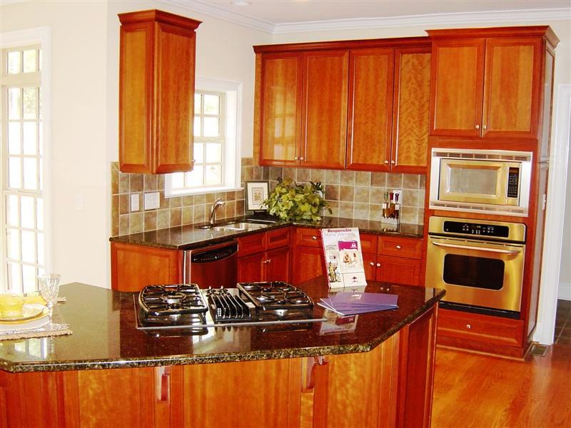 Gourmet kitchen features custom 42inch cabinets, granite counter tops, ss appliances and tile backsplash