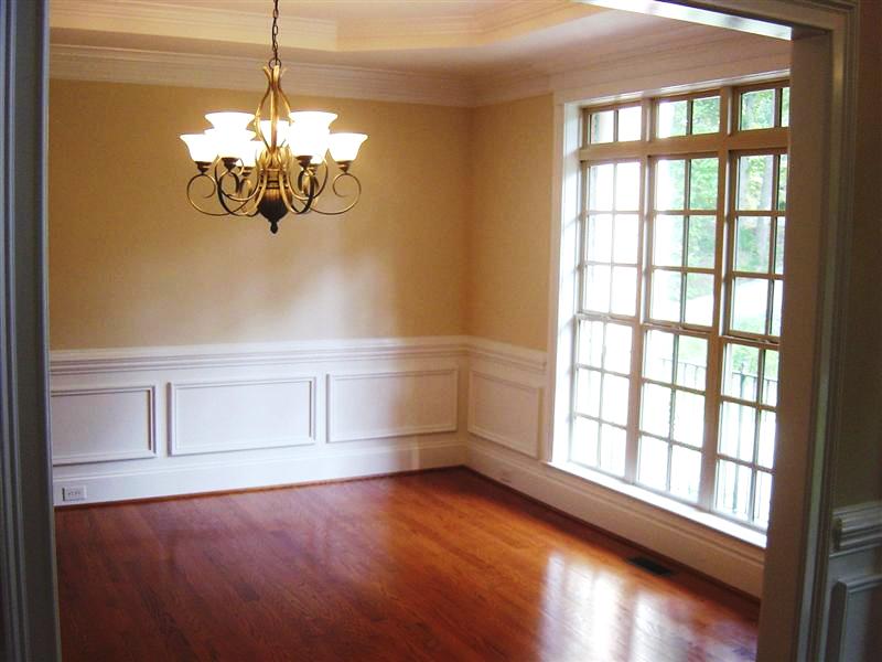 Dining room has a trey ceiling and custom moldings and millwork