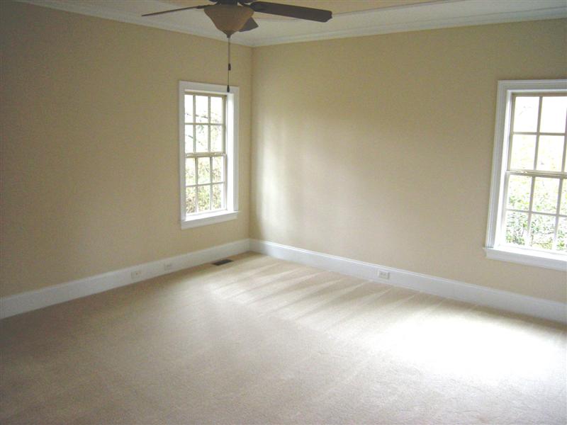 The main level master bedroom has a trey ceiling and upgraded carpet